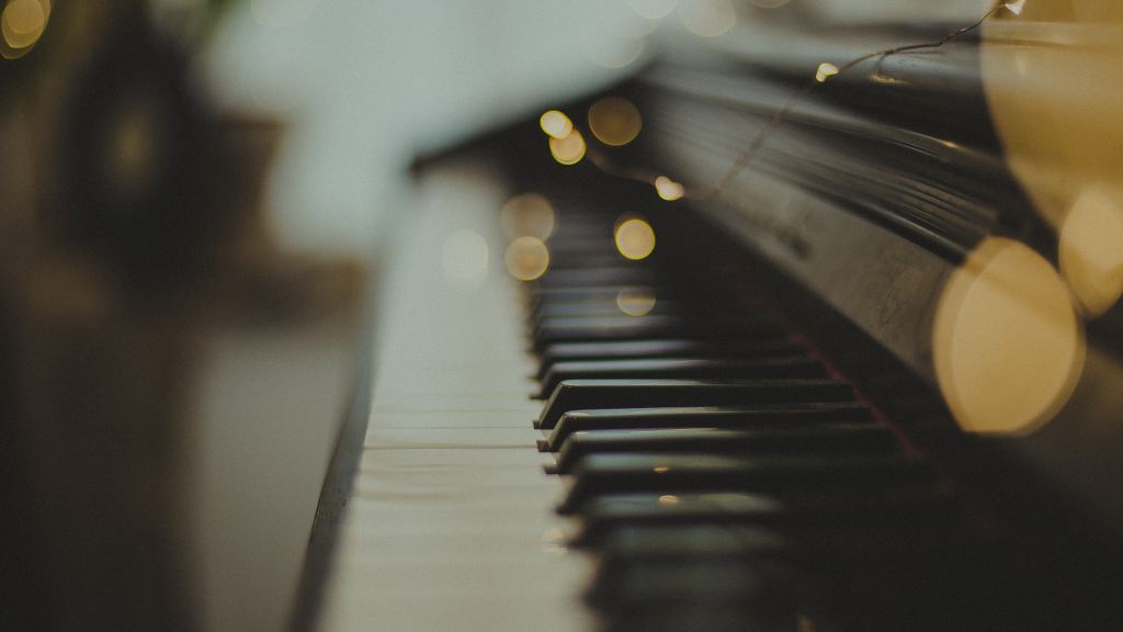 Piano instrument close up with string of electrical lights